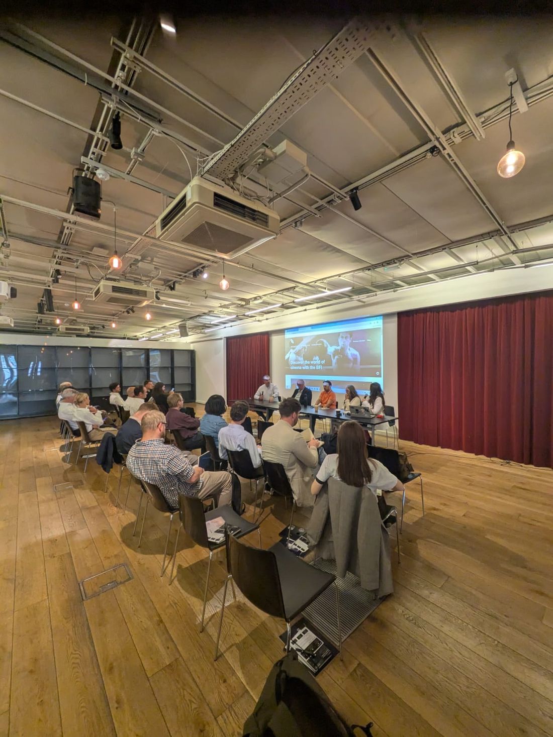 The room at a Signal Session, panel at the front and attendees leaning in